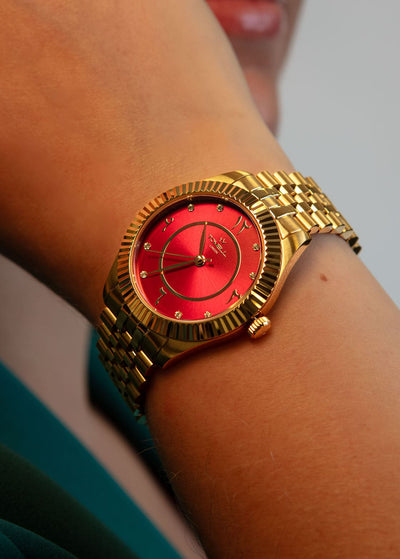 Detailed view of the watch dial showing the small, brilliant diamond stone accent at the 12 o'clock position.