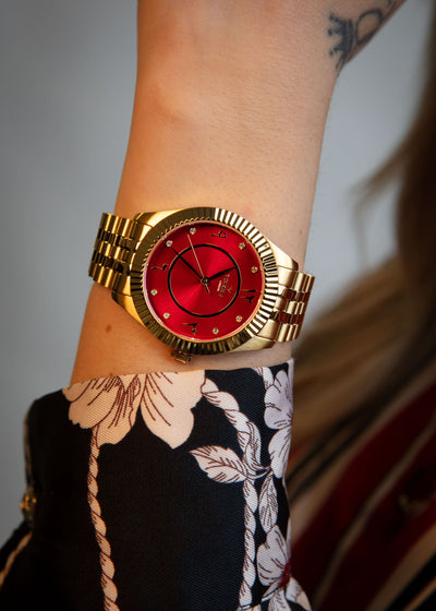 Stylish gold timepiece with Arabic markers worn on a wrist, highlighting its perfect scale.
