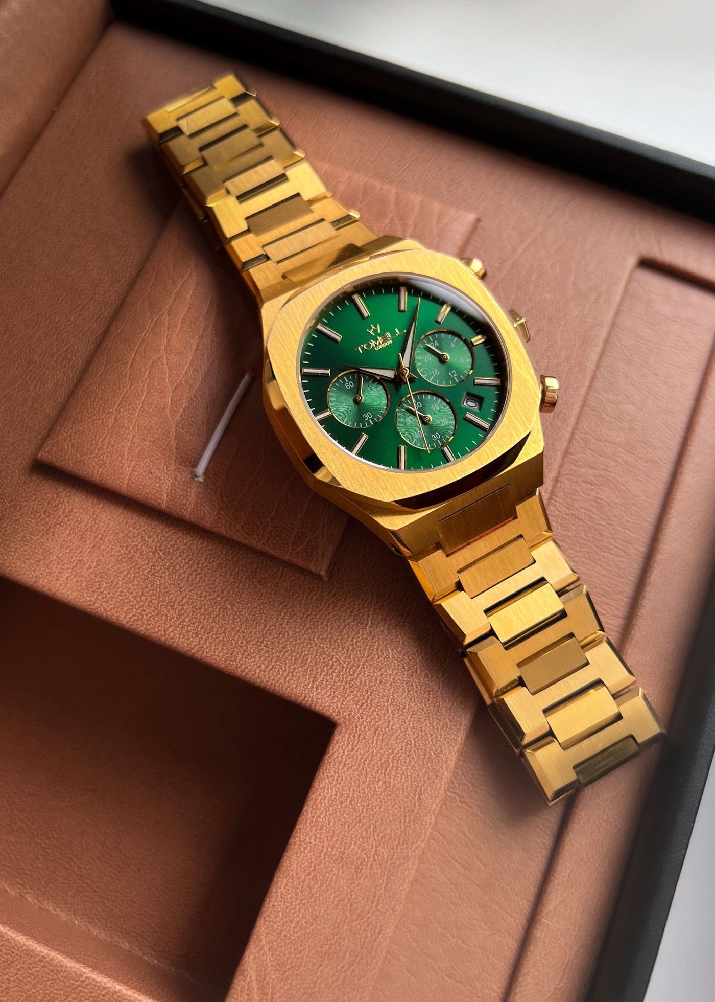 Gold watch with green face tomell London 