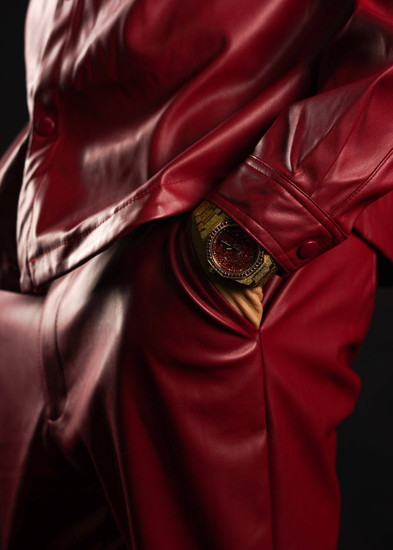 Detail shot focusing on the scintillating contrast between the warm gold frosted architecture and the intense alchemical red dial. Individual brilliant-cut diamonds frame the bezel, highlighting the exceptional design quality and unrivaled grace of this hand-picked, crimson-pulsing artifact.