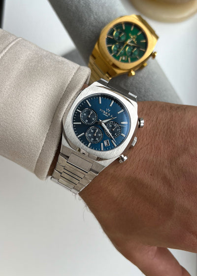 wrist wearing a silver watch with a blue face Tomell London brand one of the bestselling from motorsport collection 