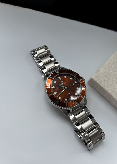 Silver watch with a brown face 