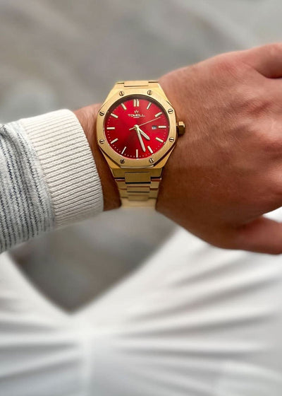 Gold watch with a red face