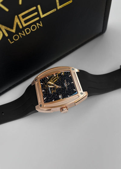 Luxury watch with rose gold case and black strap on a light gray background, featuring Tomell London branding.