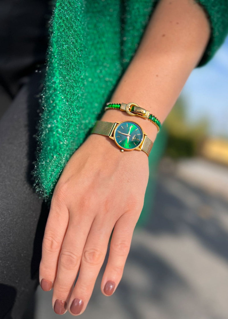 gold watch with a green face, green bracelet