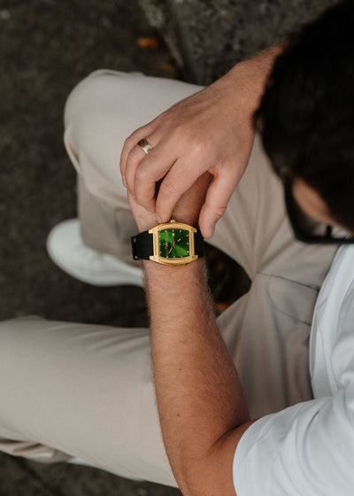 green face and gold case watch