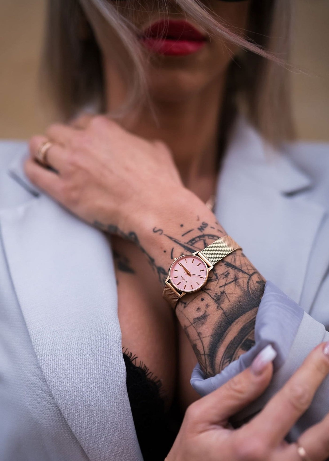 rose gold watch with a pink face with mesh strap 