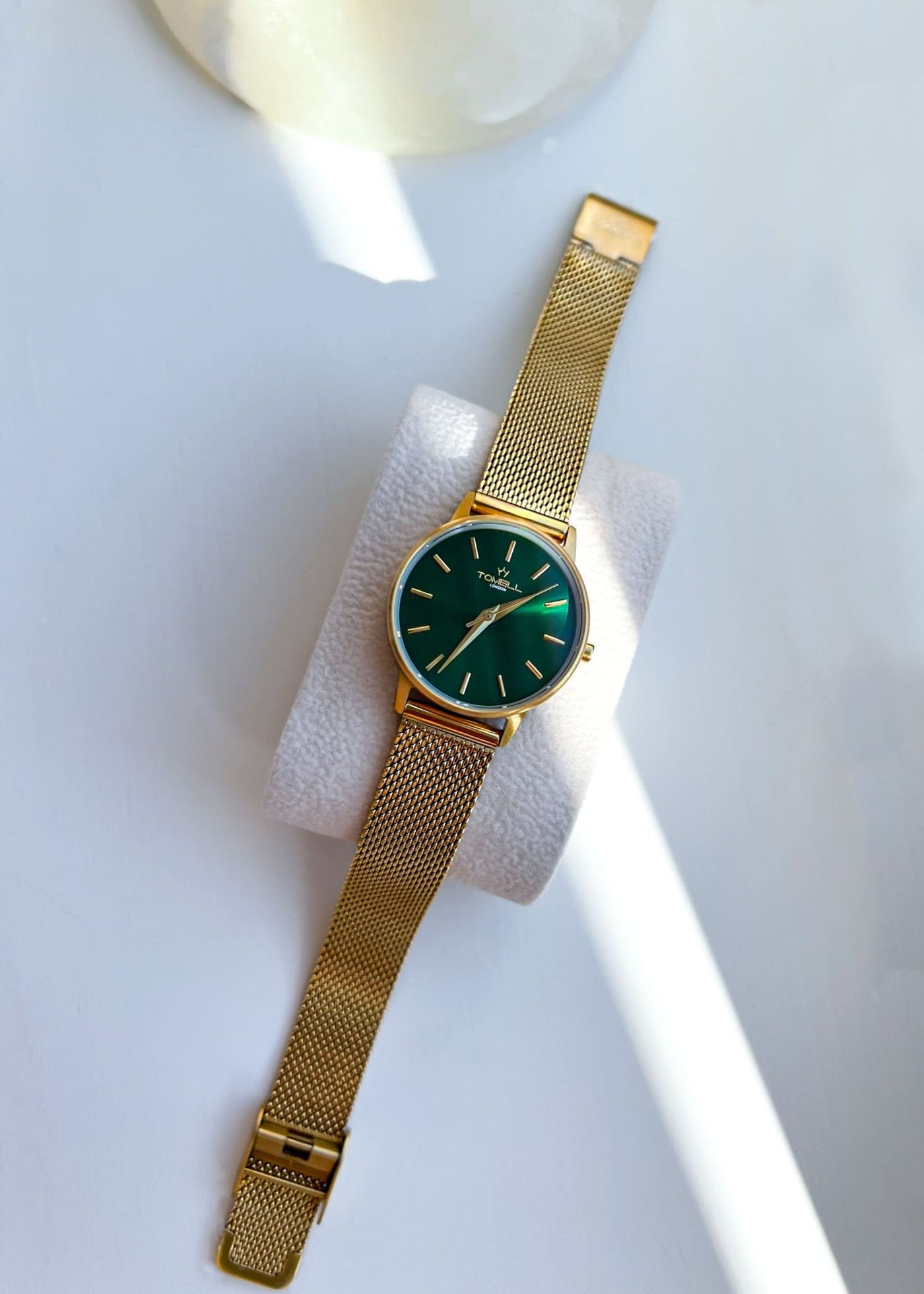 Gold watch with a green face